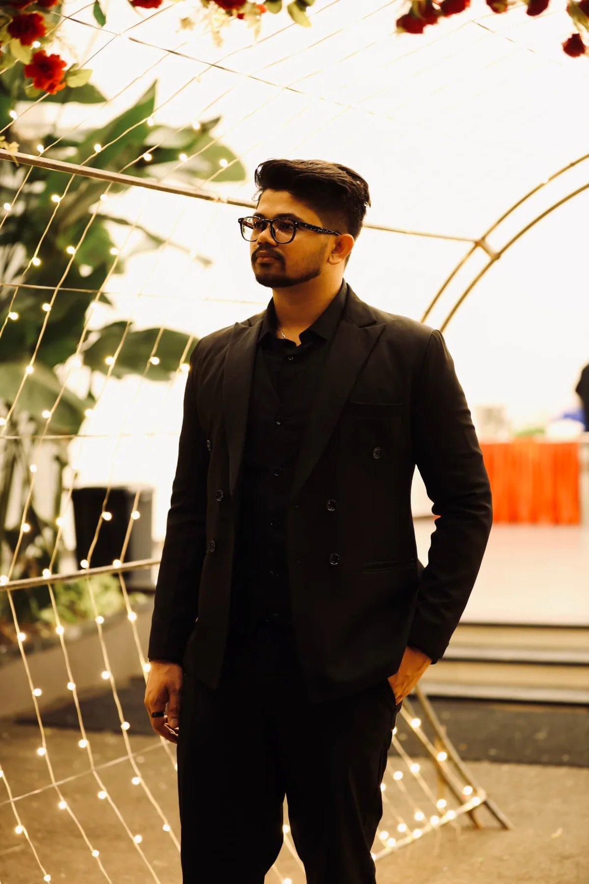 Varun Vinod standing beneath an illuminated arch